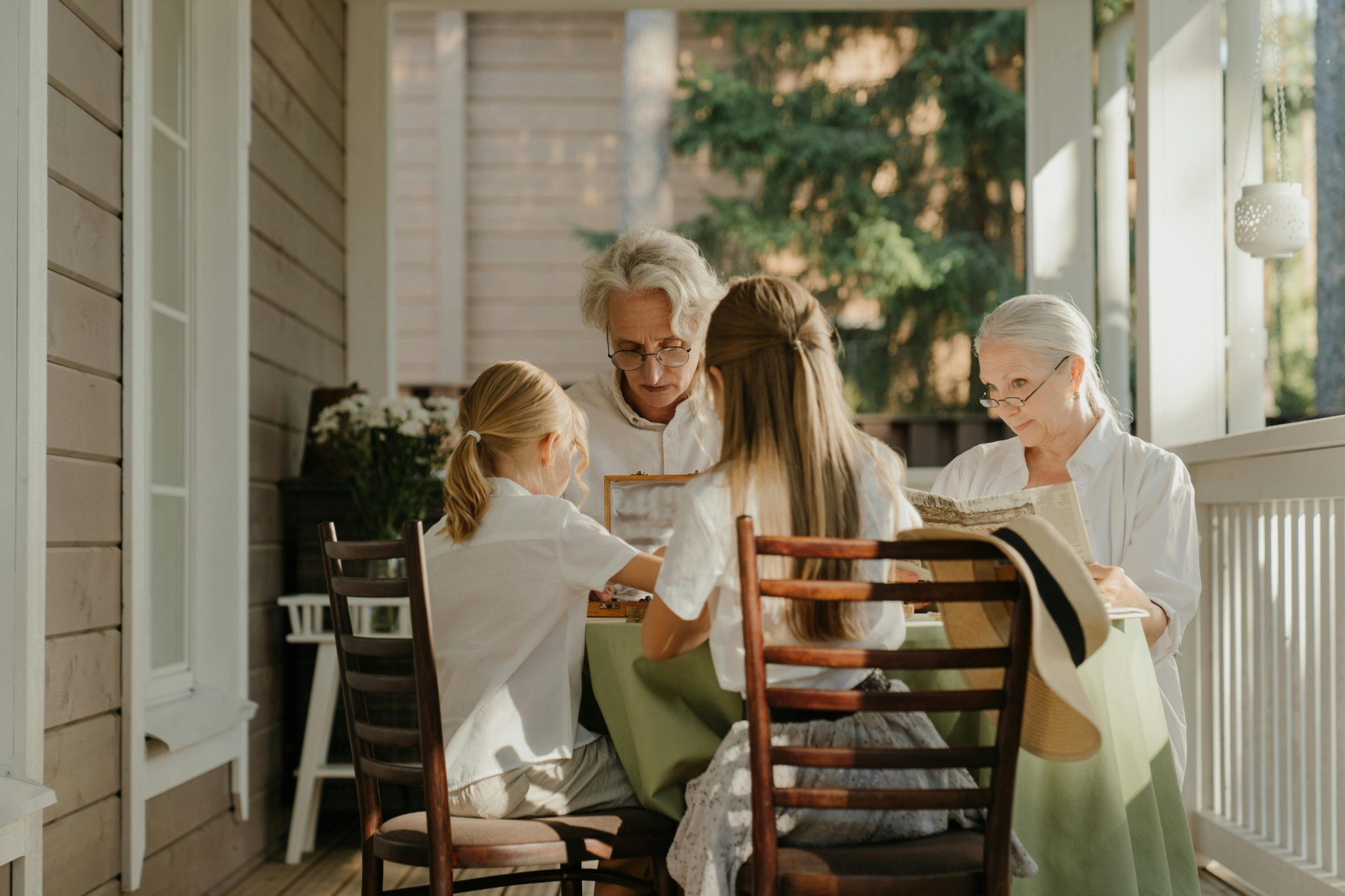 grandparents playing games with grandchildren at table
